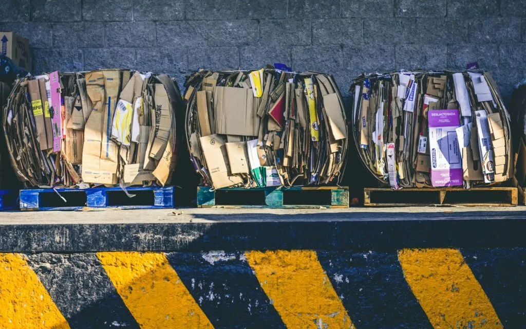 Boxes stacked on wooden pallets, prepared for an e-waste collection day
