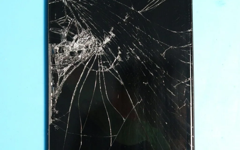 Smartphone with a cracked screen that should be recycled rather than thrown in the bin