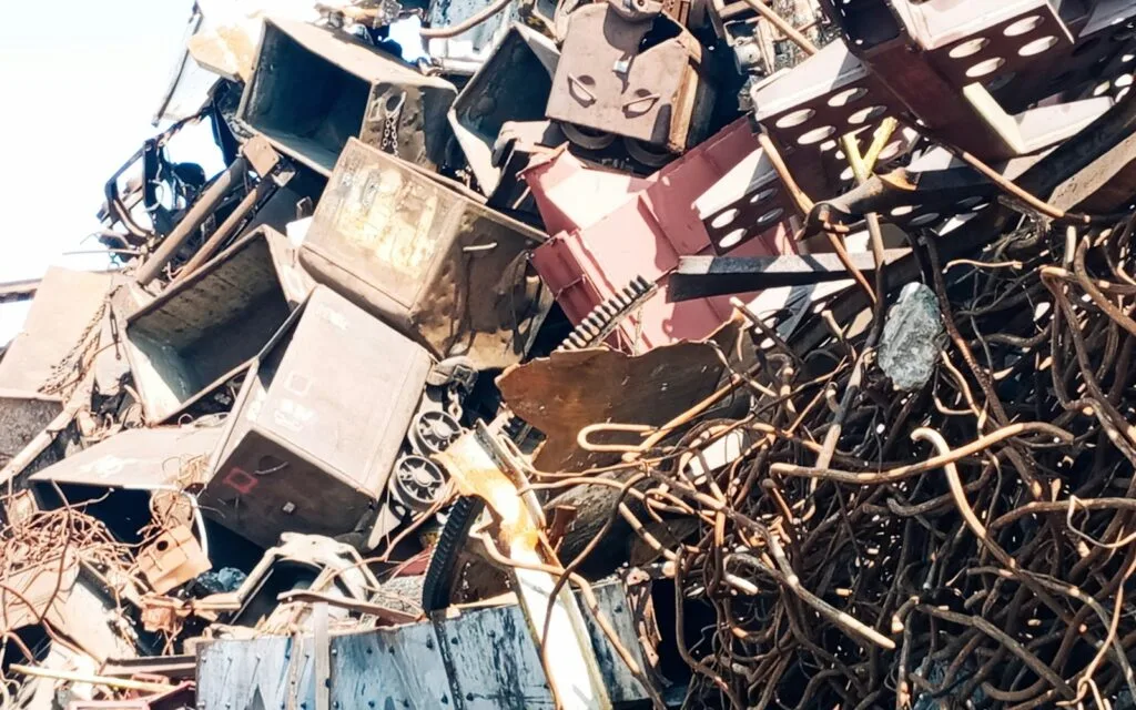 Old televisions piled on top of other junk, showing the growing volume of e-waste