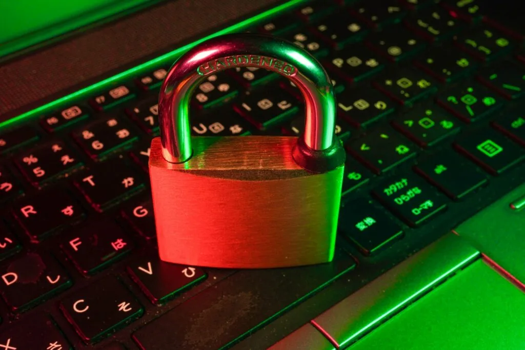 Red padlock on a computer keyboard, representing the risk of a data breach from improperly disposed IT equipment