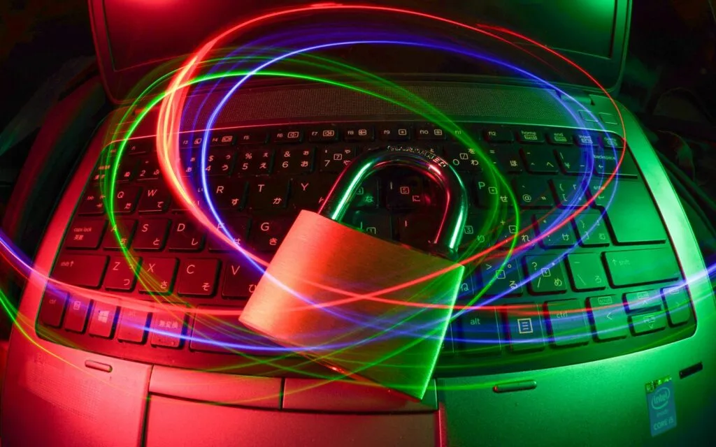 Padlock on a laptop keyboard, symbolising data security during IT asset disposition